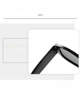 Detailed close-up of the durable hinge and frame connection on black retro sunglasses