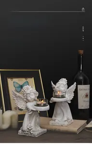Close-up of vintage white angel candle holder with glass cup on dark background