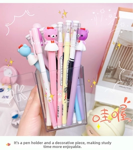Close-up of macaron color gel pens with cute 3D bear figures and clear acrylic pen holder