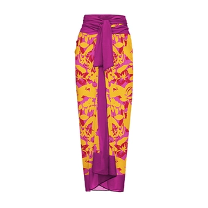 Detailed view of the purple tropical floral print and waist tie on the beach wrap skirt