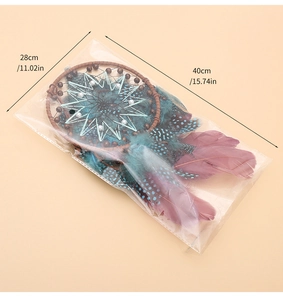 Detailed view of handmade dream catcher with size specs 28cm and 40cm on beige background