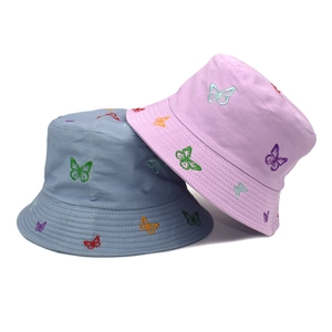 Detailed view of colorful butterfly embroidery and reinforced stitching on cotton bucket hats
