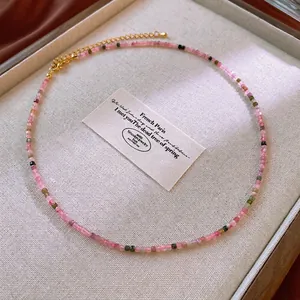 Colorful natural stone beaded necklace with gold clasp on an elegant jewelry tray