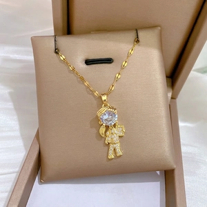 Elegant gold girl pendant necklace with full cubic zirconia stones on brushed jewelry box