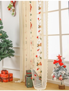 Detail of Christmas lace curtain with bell embroidery and festive holiday decor
