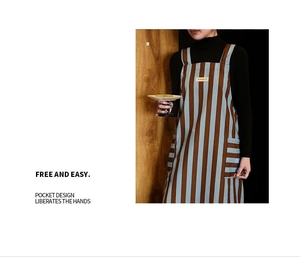 Detail showing blue and brown striped apron with multiple pockets and professional stitching