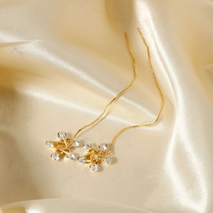 Exquisite gold tassel star earrings with cubic zirconia on luxury silk background