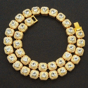 Golden heart-shaped Cuban link necklace with large clear zircons on black background
