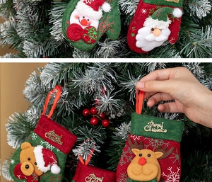 Detail of Christmas glove and boot ornaments with plush Santa and reindeer figures