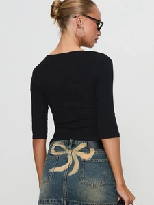 Slim fit black knitted t-shirt paired with denim skirt featuring bow pattern on back