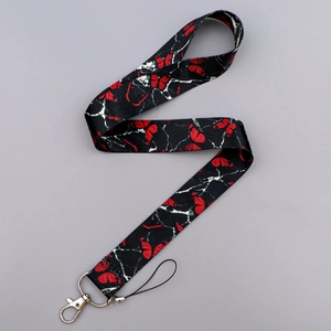 Detailed view of butterfly and marble print lanyard with sturdy silver lobster clasp