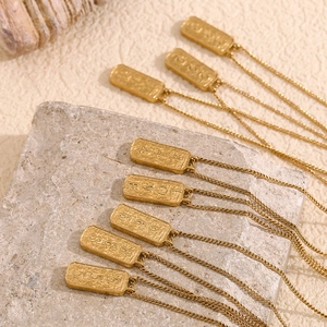 Close-up of rectangular tarot pendant necklaces in 18K gold plated stainless steel