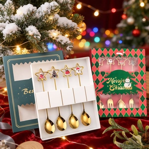 Golden Christmas spoon set with festive cartoon charms in a holiday gift box