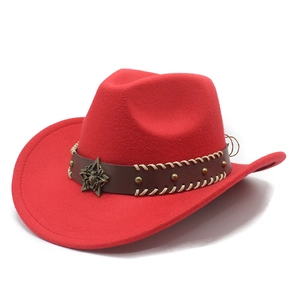 Detail of red wool felt western cowboy hat with studded leather band and bronze star