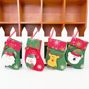 Detail view of 4 mini Christmas stockings with Santa, snowman, reindeer and bear felt patches