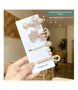 Close-up of 4pcs pearl and rhinestone hair clips set with gold-plated alloy base