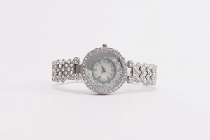 Macro shot of a silver luxury quartz watch with sparkling crystals and Arabic numerals