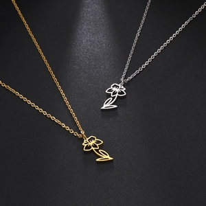 Elegant stainless steel necklaces with gold and silver floral cutout pendants on black