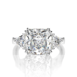 Macro shot of three-stone silver ring featuring a radiant cut main stone and side accents