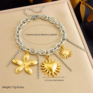 Mixed metal chain bracelet with floral and sun pendants in silver and gold tones