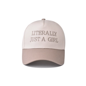 Close-up of 'LITERALLY JUST A GIRL' embroidery on a two-tone cotton baseball cap