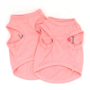 Detail showing two pink cotton pet vests with I heart print and sleeveless design