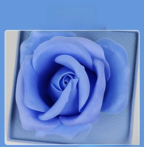 Detail of blue soap rose inside a textured jewelry drawer gift box with layered petals
