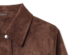 Detail of brown suede jacket showing collar, shoulder seam and silver button texture