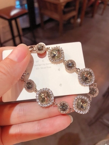 Macro view of champagne gemstones and 925 silver post on rose gold plated bracelet