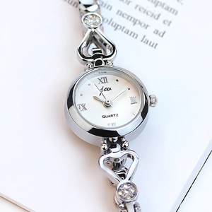 Silver quartz watch with heart-shaped metal strap and crystal accents on white dial