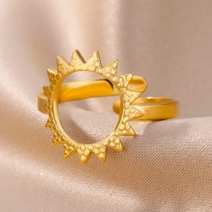 Macro shot of 18k gold plated stainless steel ring with sunburst design on satin