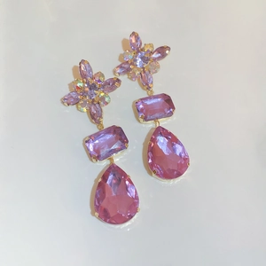 Elegant vintage purple crystal teardrop earrings with gold-toned flower design on white