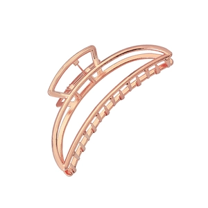 Detailed view of large rose gold geometric metal hair claw clip with sleek crescent design