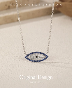 Macro detail of S925 silver necklace with blue evil eye pendant and sparkling crystals