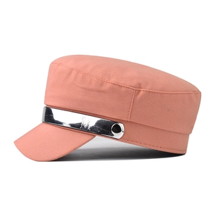 Detail of salmon pink flat top military cap with embossed silver metal band and M letter