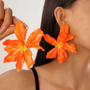 Statement orange acrylic flower earrings with 3D petals for a vacation beach look