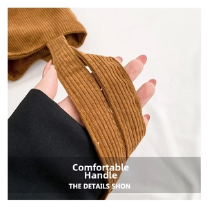 Close-up of caramel corduroy tote bag handle with reinforced stitching detail