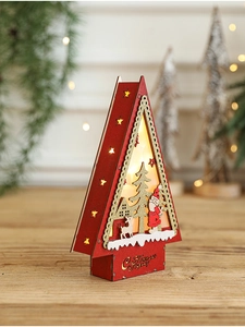 Detail of red wooden Christmas house with LED warm light and Santa Claus deer engraving