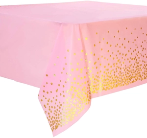 Close-up of pink disposable tablecloth featuring shiny golden gradient polka dot confetti