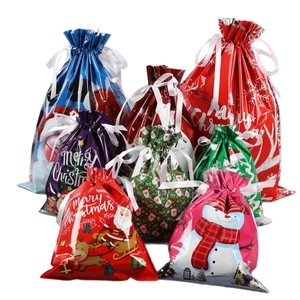 Assorted Christmas drawstring gift bags with festive Santa and snowman patterns