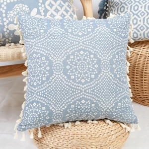 Detailed close-up of blue floral print pillowcase showing cotton linen texture and tassels