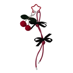 Handmade cherry keychain with red plush fruit and velvet bows on white background