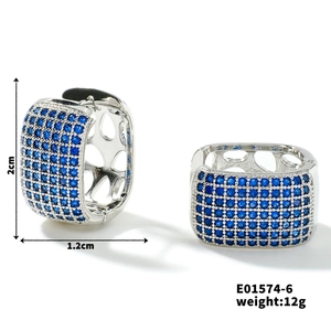 Detail view of silver hollow earrings with blue zircon inlays including size dimensions