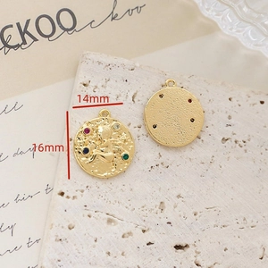 Detailed view of 14mm vintage gold angel pendant with colorful cubic zirconia stones