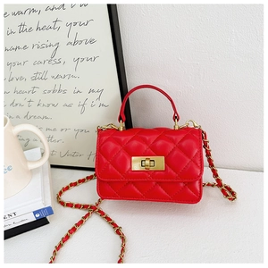 Detail of red quilted mini bag featuring a gold twist lock and leather chain strap