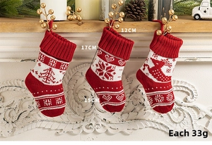 Detail showing dimensions of red knitted Christmas stockings with elk and tree patterns