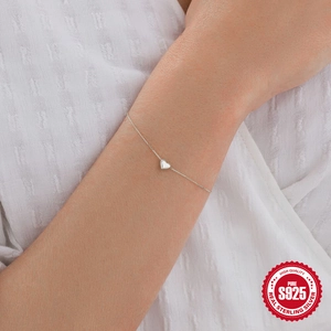 Minimalist S925 sterling silver heart bracelet worn on wrist for daily commute fashion
