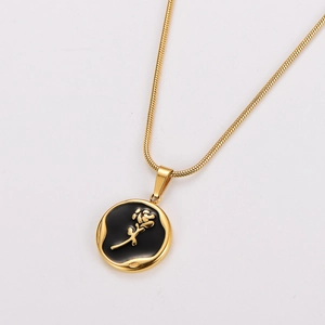 Macro detail of a golden stainless steel snake chain necklace with black rose pendant