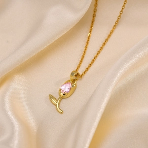 Close-up of tulip pendant with pink zircon on champagne silk background