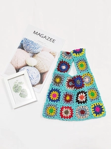 Detailed handmade crochet tote bag with colorful granny square patterns on blue base